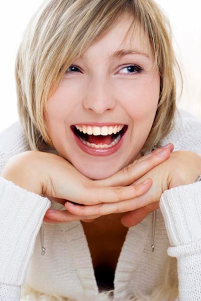 woman smiling with her new dental veneers from Capitol Lake Dentistry