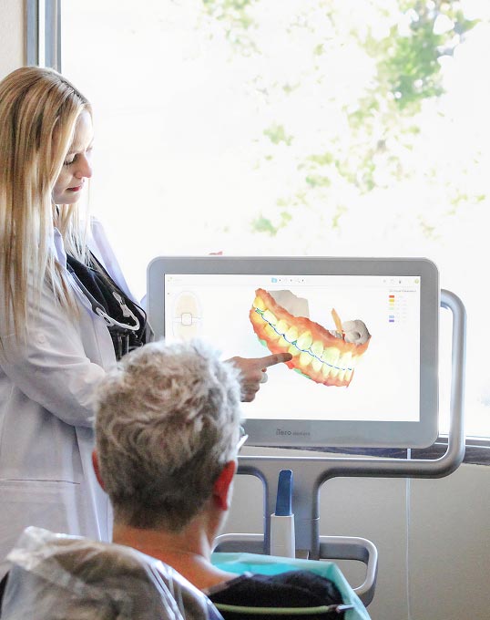 Olympia dentist Dr. Evans providing patient with care