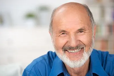 man with dental crowns smiling