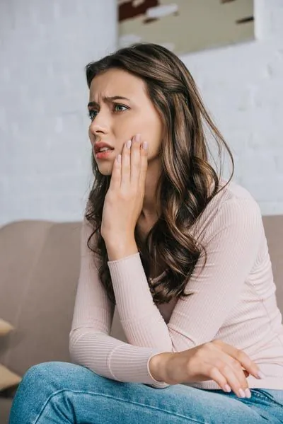 woman with tooth pain needing emergency dentistry in Olympia, WA