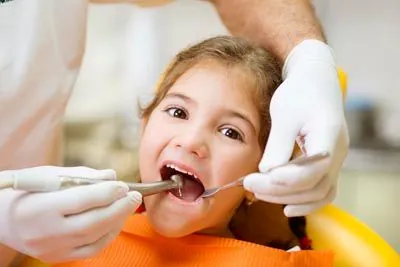 young girl getting her teeth cleaned at the dentist