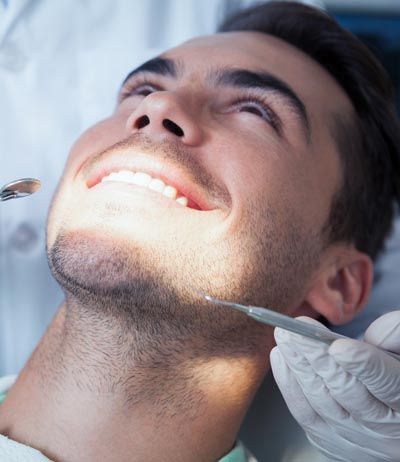 man getting dental treatment at Capitol Lake Dentistry