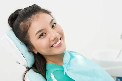 woman smiling getting her restorative dental care at Capitol Lake Dentistry